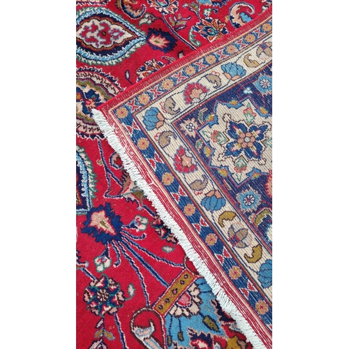 145 - A VERY FINE PERSIAN MASHAD FLOOR RUG, with brightly coloured red main ground, with indigo, pale blue... 