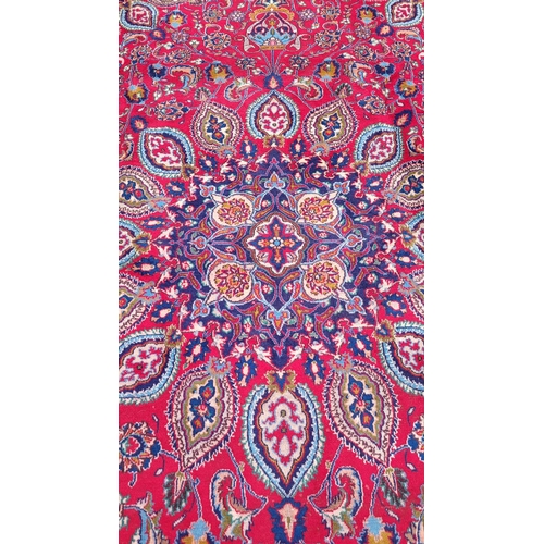 145 - A VERY FINE PERSIAN MASHAD FLOOR RUG, with brightly coloured red main ground, with indigo, pale blue... 