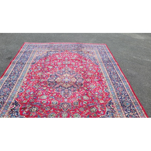 151 - A PERSIAN MASHAD FLOOR RUG, with central medallion motif, surrounded by intertwined floral and folia... 