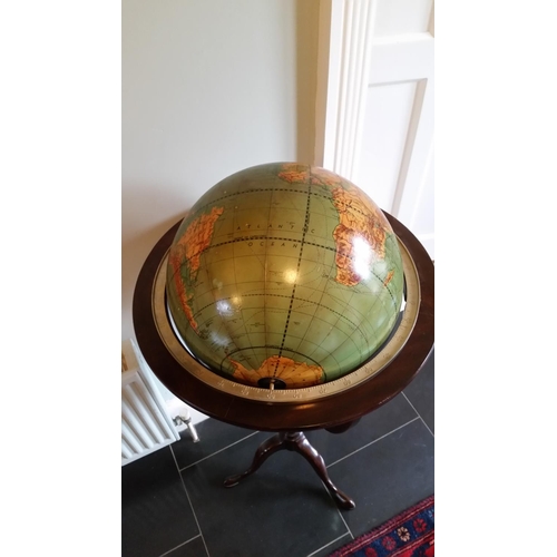 168 - A MID 20TH CENTURY REVOING GLOBE ON A MAHOGANY STAND, in the Georgian style; The stem with turned an... 