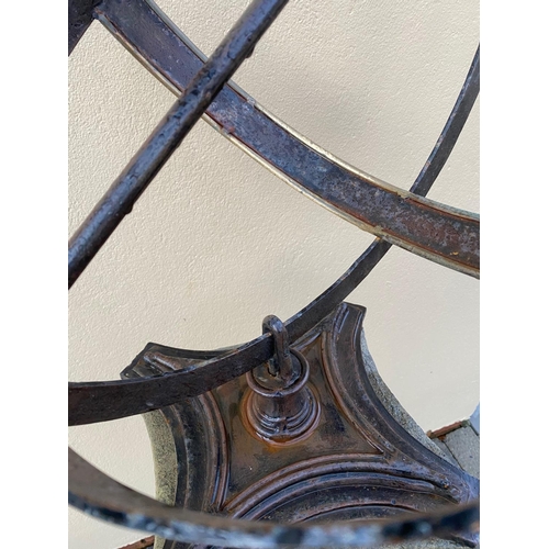 178 - A CAST IRON ARMILLARY SUN DIAL, sitting upon a Corinthian style column base. 148cm tall.