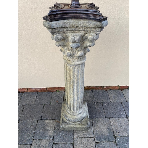 178 - A CAST IRON ARMILLARY SUN DIAL, sitting upon a Corinthian style column base. 148cm tall.