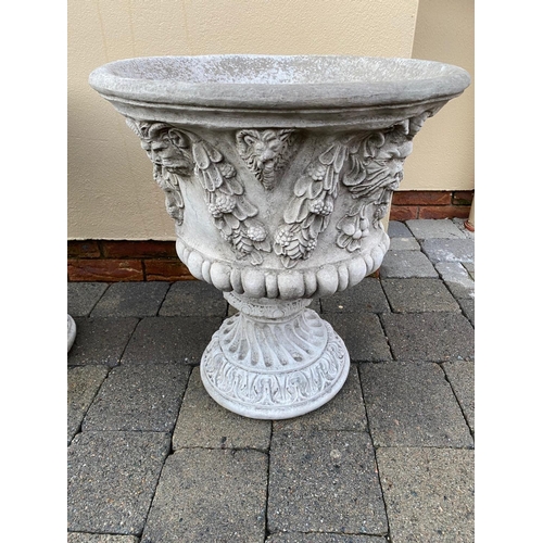 179 - A GOOD PAIR OF STONE GARDEN URNS, each decorated with fruit, leaves and lions heads. Round shape. 52... 