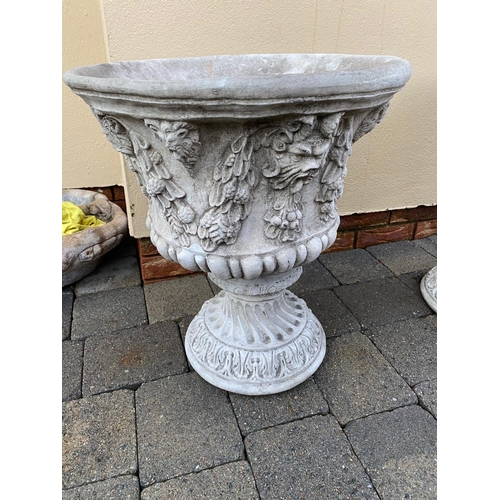 179 - A GOOD PAIR OF STONE GARDEN URNS, each decorated with fruit, leaves and lions heads. Round shape. 52... 