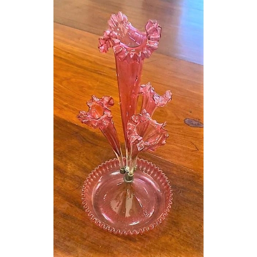 187 - A 19TH CENTURY CRANBERRY GLASS EPERGNE, consisting of four pinched floral shaped trumpet braches, th... 