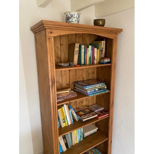 198 - A PINE FIVE DRAWER OPEN BOOKCASE, with flared cornice, on platform base. Dimensions: 35in wide x 6ft... 