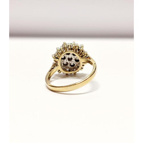 20 - A CHARMING 9CT YELLOW GOLD ILLUSION SET DIAMOND CLUSTER RING, the illusion setting helps to create a... 