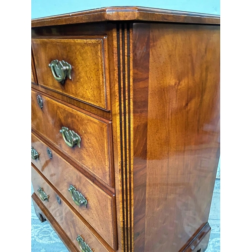 21 - AN ANTIQUE STYLE WALNUT DRINKS CABINET / MUSIC CABINET, the front has four faux drawers over a singl... 