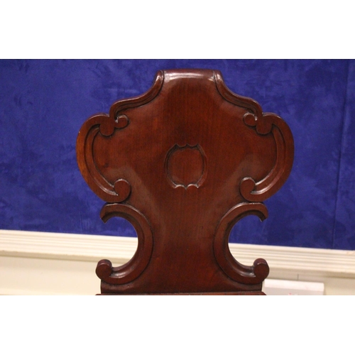 22 - A FINE MATCHING PAIR OF 19TH CENTURY IRISH MAHOGANY HALL CHAIRS, with carved scroll motif to the bac... 