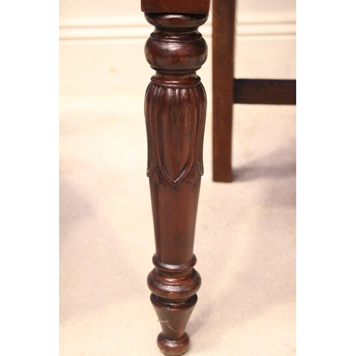 22 - A FINE MATCHING PAIR OF 19TH CENTURY IRISH MAHOGANY HALL CHAIRS, with carved scroll motif to the bac... 