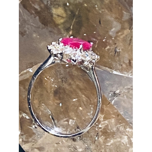 35 - A STUNNING 18CT WHITE GOLD BURMESSE RUBY & DIAMOND CLUSTER RING; the centrally placed Burmese ruby w... 