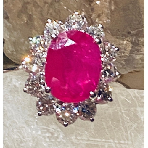 35 - A STUNNING 18CT WHITE GOLD BURMESSE RUBY & DIAMOND CLUSTER RING; the centrally placed Burmese ruby w... 