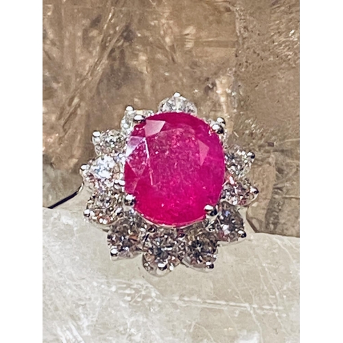 35 - A STUNNING 18CT WHITE GOLD BURMESSE RUBY & DIAMOND CLUSTER RING; the centrally placed Burmese ruby w... 