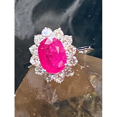 35 - A STUNNING 18CT WHITE GOLD BURMESSE RUBY & DIAMOND CLUSTER RING; the centrally placed Burmese ruby w... 