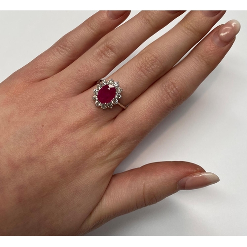 35 - A STUNNING 18CT WHITE GOLD BURMESSE RUBY & DIAMOND CLUSTER RING; the centrally placed Burmese ruby w... 