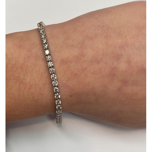 37 - A GORGEOUS 18CT WHITE GOLD DIAMOND TENNIS BRACELET, this is the gift of a lifetime! Be that for your... 