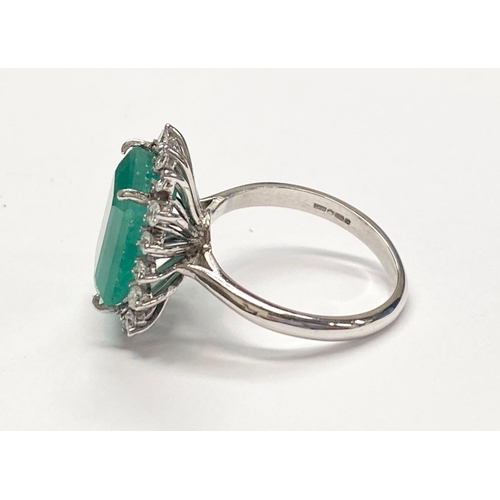 50 - A UNIQUE 18CT GOLD EMERALD AND DIAMOND CLUSTER RING, with beautiful 4.7ct central emerald surrounded... 