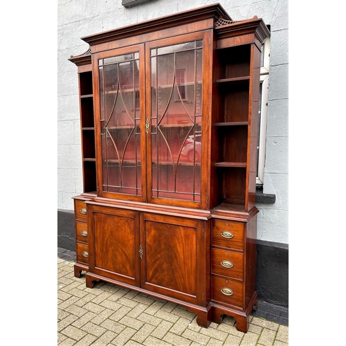 59 - AN IRISH GEROGIAN STYLE MAHOGANY BREAKFRONT LIBRARY BOOKCASE, a very fine piece of cabinetry with el... 