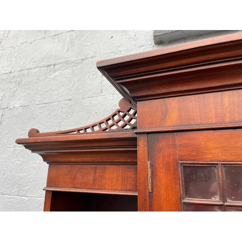 59 - AN IRISH GEROGIAN STYLE MAHOGANY BREAKFRONT LIBRARY BOOKCASE, a very fine piece of cabinetry with el... 