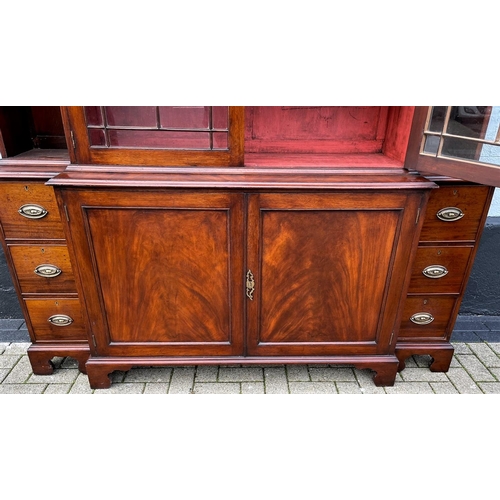 59 - AN IRISH GEROGIAN STYLE MAHOGANY BREAKFRONT LIBRARY BOOKCASE, a very fine piece of cabinetry with el... 