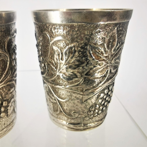 65 - TWO SILVER GRAPE VINE CUPS, each decorated all over with a grape and vine decoration, marked 800. Po... 