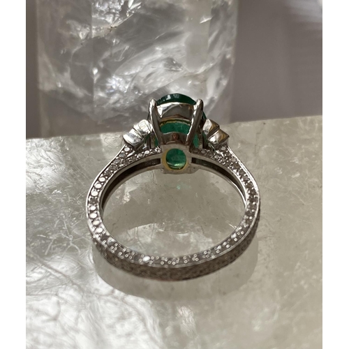 69 - AN 18CT WHITE GOLD NATURAL COLUMBIAN EMERALD & DIAMOND RING, the ring has a centrally set oval shape... 