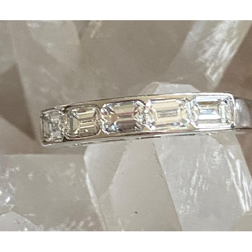 74 - A BEAUTIFUL PATINUM BAGUETTE CUT FIVE STONE DIAMOND RING, set in a half eternity setting, crafted fr... 