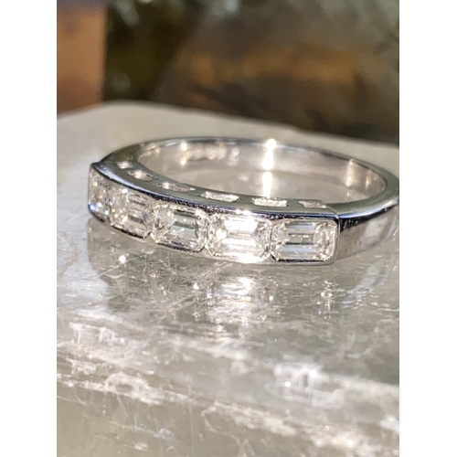 74 - A BEAUTIFUL PATINUM BAGUETTE CUT FIVE STONE DIAMOND RING, set in a half eternity setting, crafted fr... 