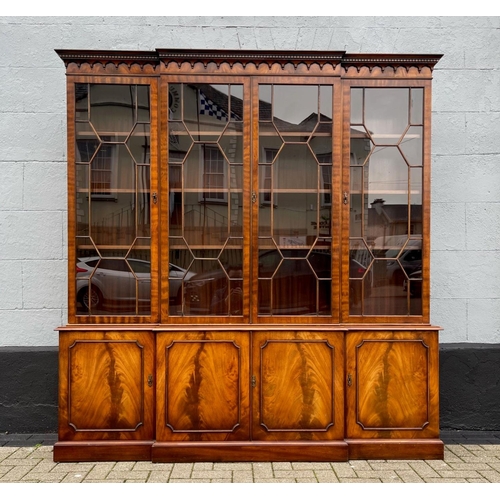 82 - A GOOD QUALITY BREAK-FRONT LIBRARY GLAZED BOOKCASE, to the top is a moulded dentil cornice with four... 