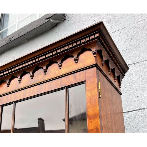 82 - A GOOD QUALITY BREAK-FRONT LIBRARY GLAZED BOOKCASE, to the top is a moulded dentil cornice with four... 