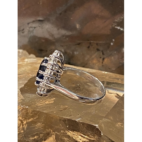 93 - AN 18CT WHITE GOLD SAPPHIRE & DIAMOND CLUSTER RING, with a central oval shaped sapphire stone weighi... 