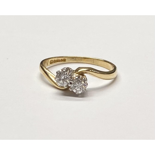 94 - AN 18CT YELLOW GOLD CLASSIC DIAMOND TWIST RING, with two round brilliant cut diamonds in a claw sett... 