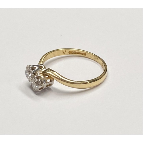 94 - AN 18CT YELLOW GOLD CLASSIC DIAMOND TWIST RING, with two round brilliant cut diamonds in a claw sett... 