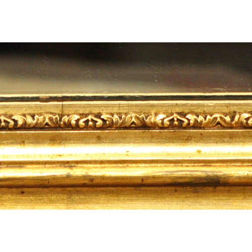 104 - AN ANTIQUE GILT WALL MIRROR, 	shaped in a rectangular form; this gilt mirror is beautifully adorned ... 