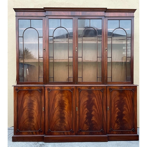 108 - A LARGE MAHOGANY BREAK-FRONT GLAZED LIBRARY BOOKCASE, the pediment with dentil moulding, each of the... 