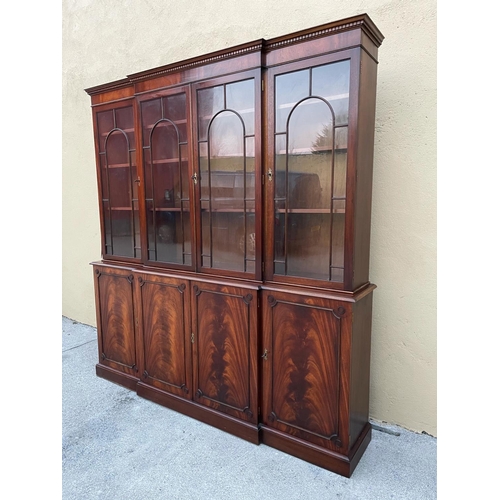 108 - A LARGE MAHOGANY BREAK-FRONT GLAZED LIBRARY BOOKCASE, the pediment with dentil moulding, each of the... 