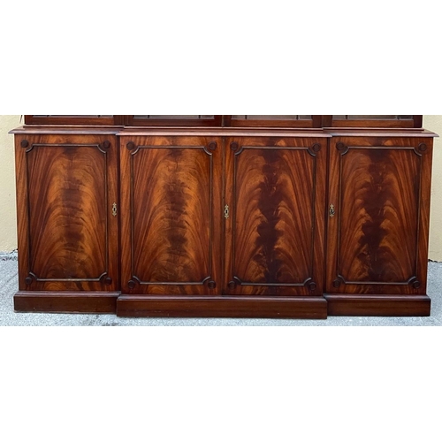 108 - A LARGE MAHOGANY BREAK-FRONT GLAZED LIBRARY BOOKCASE, the pediment with dentil moulding, each of the... 