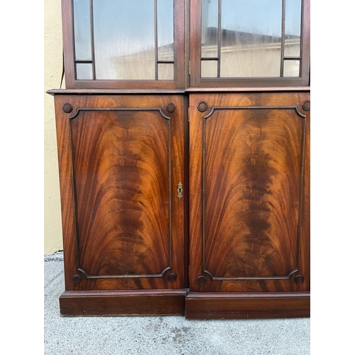 108 - A LARGE MAHOGANY BREAK-FRONT GLAZED LIBRARY BOOKCASE, the pediment with dentil moulding, each of the... 