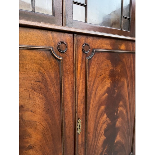 108 - A LARGE MAHOGANY BREAK-FRONT GLAZED LIBRARY BOOKCASE, the pediment with dentil moulding, each of the... 