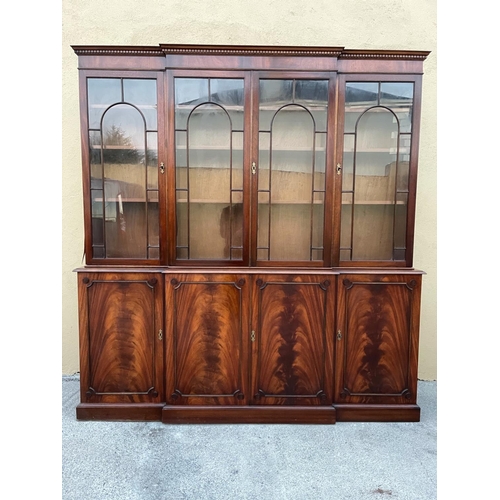 108 - A LARGE MAHOGANY BREAK-FRONT GLAZED LIBRARY BOOKCASE, the pediment with dentil moulding, each of the... 