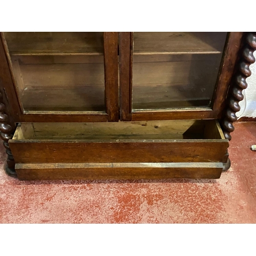 120 - A 19TH CENTURY IRISH OAK TWO DOOR GLAZED CABINET, with a tapered pediment over a line of bold dentil... 