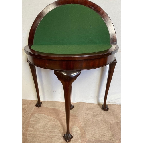 124 - A GOOD MAHOGANY DEMI LUNE FOLD OVER CARD TABLE, with gadrooned edge, standing on claw and ball feet.... 