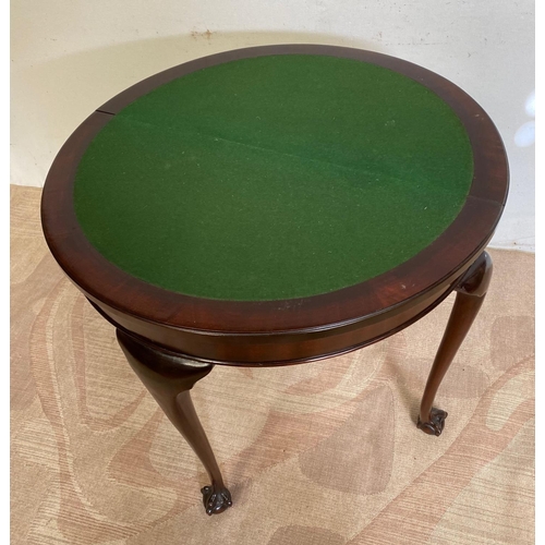 124 - A GOOD MAHOGANY DEMI LUNE FOLD OVER CARD TABLE, with gadrooned edge, standing on claw and ball feet.... 