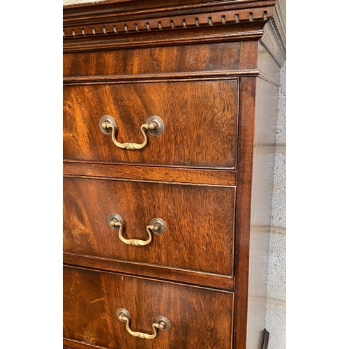 128 - A GEORGIAN STYLE MAHOGANY CHEST ON CHEST, with moulded dentil cornice to the top over eight drawers;... 