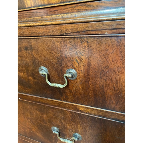 128 - A GEORGIAN STYLE MAHOGANY CHEST ON CHEST, with moulded dentil cornice to the top over eight drawers;... 