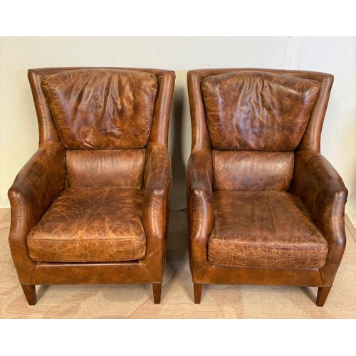 13 - A GOOD QUALITY PAIR OF TAN LEATHER WINGBACK ARMCHAIRS. Dimensions: 71cm x 76cm x 96cm approx.