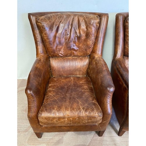 13 - A GOOD QUALITY PAIR OF TAN LEATHER WINGBACK ARMCHAIRS. Dimensions: 71cm x 76cm x 96cm approx.