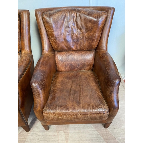 13 - A GOOD QUALITY PAIR OF TAN LEATHER WINGBACK ARMCHAIRS. Dimensions: 71cm x 76cm x 96cm approx.