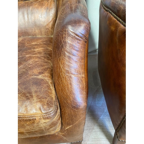 13 - A GOOD QUALITY PAIR OF TAN LEATHER WINGBACK ARMCHAIRS. Dimensions: 71cm x 76cm x 96cm approx.