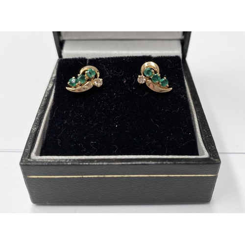 143 - AN ELEGANT PAIR OF 14CT YELLOW GOLD EMERALD & DIAMOND CROSSOVER STYLE EARRINGS; each earring with 3 ... 